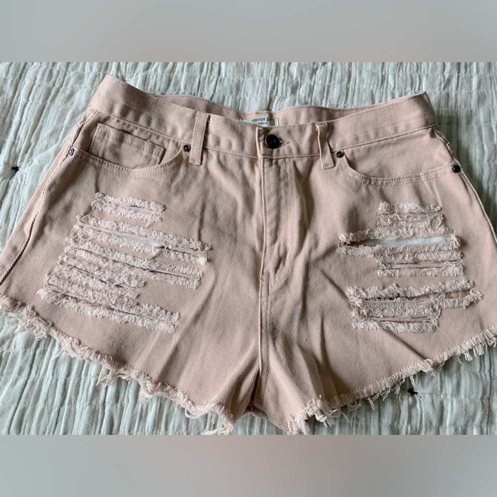 Woman’s. High rise, distressed, light pink shorts.
